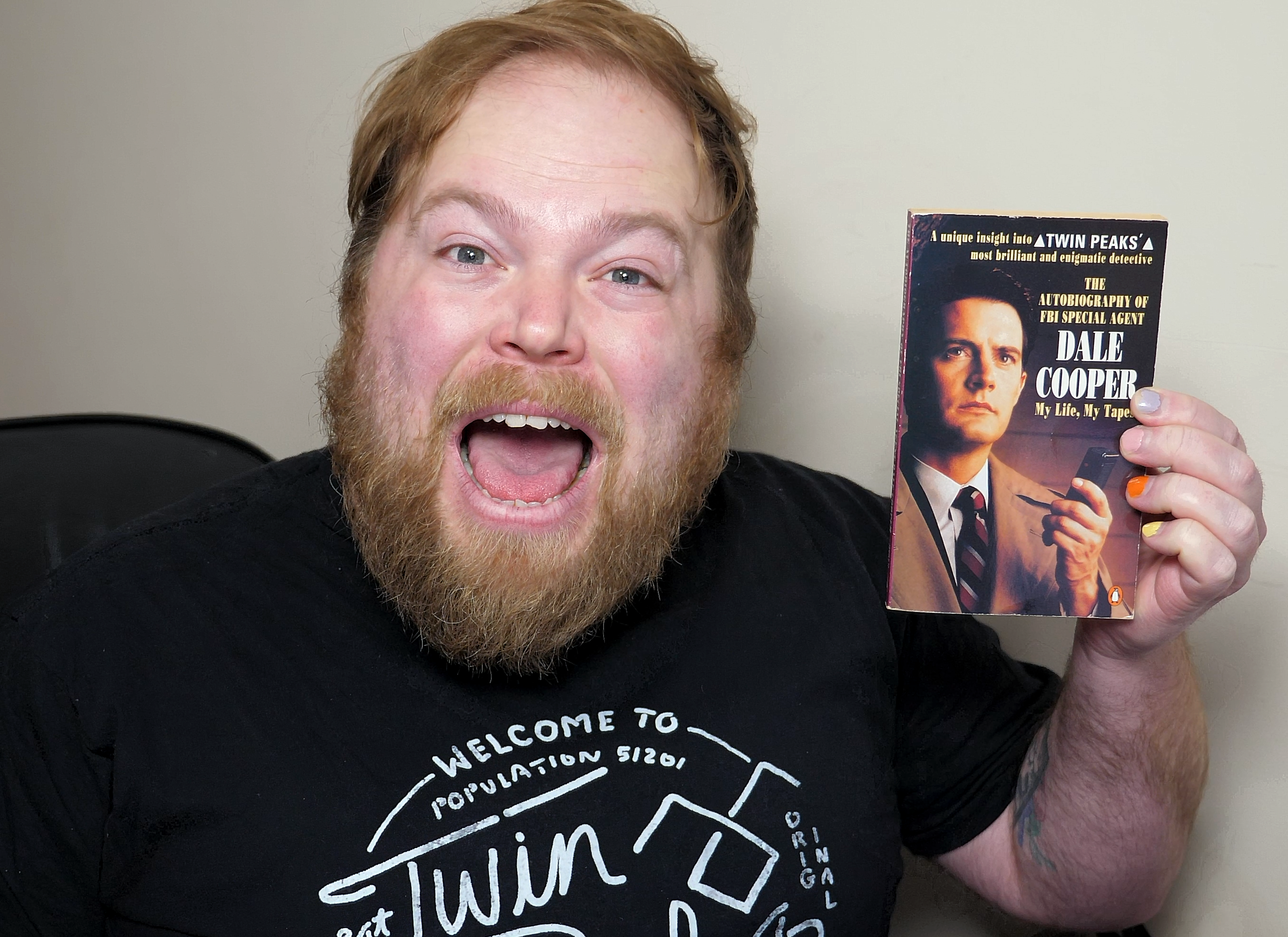 Twin peaks fan holding a book